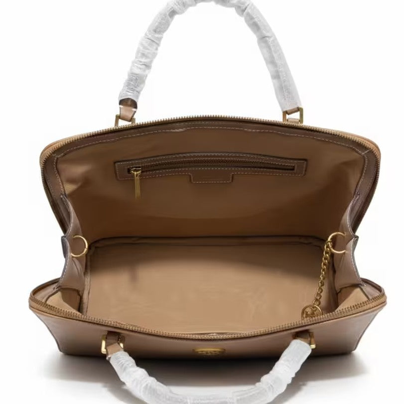 The T Burch Jacquard Swing Satchel.